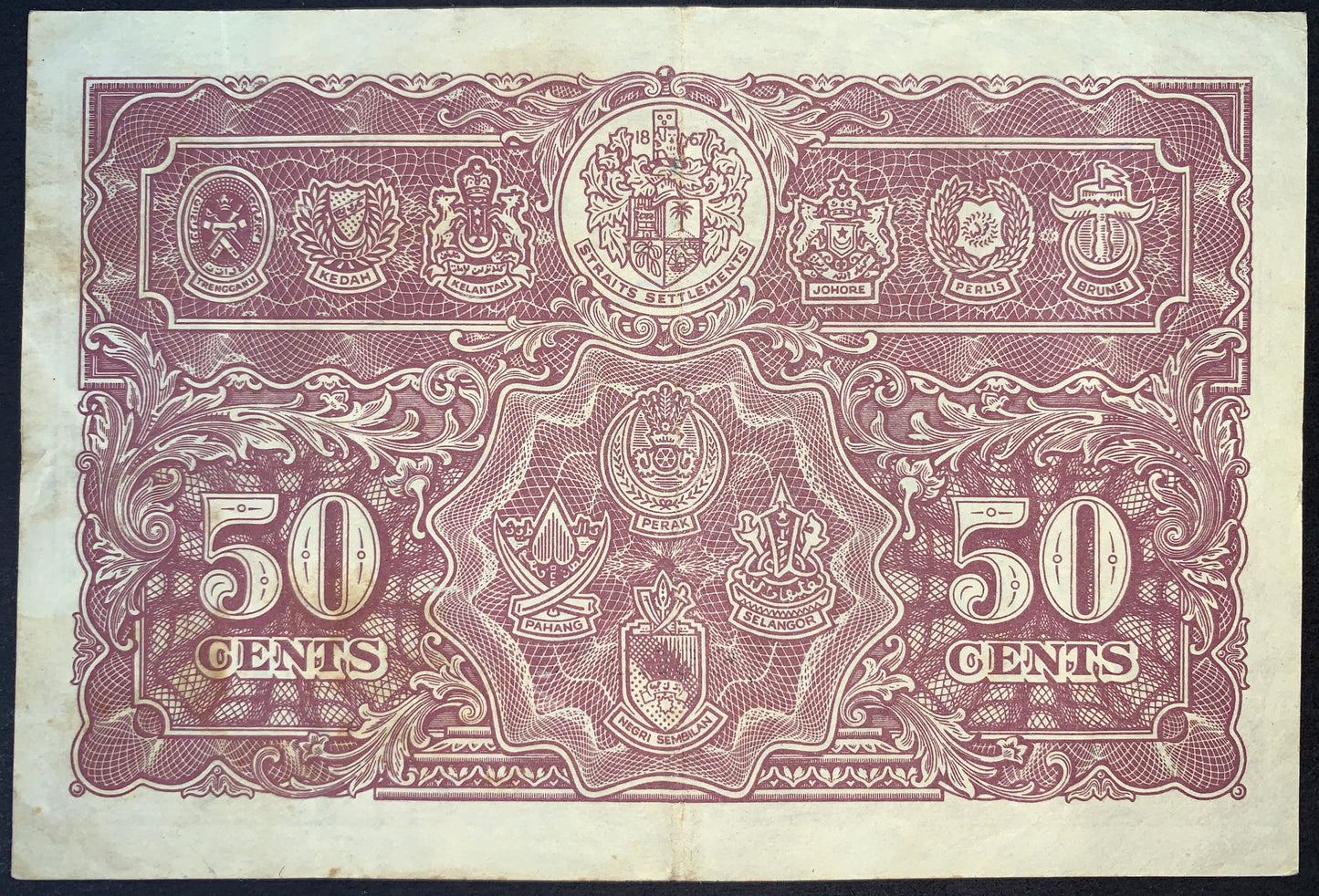 Reverse of authentic Malaya 50 Cents 1941 banknote Pick P-10 displaying the coats of arms of the Straits Settlements and Malay States, Very Fine (VF) collectible banknote.