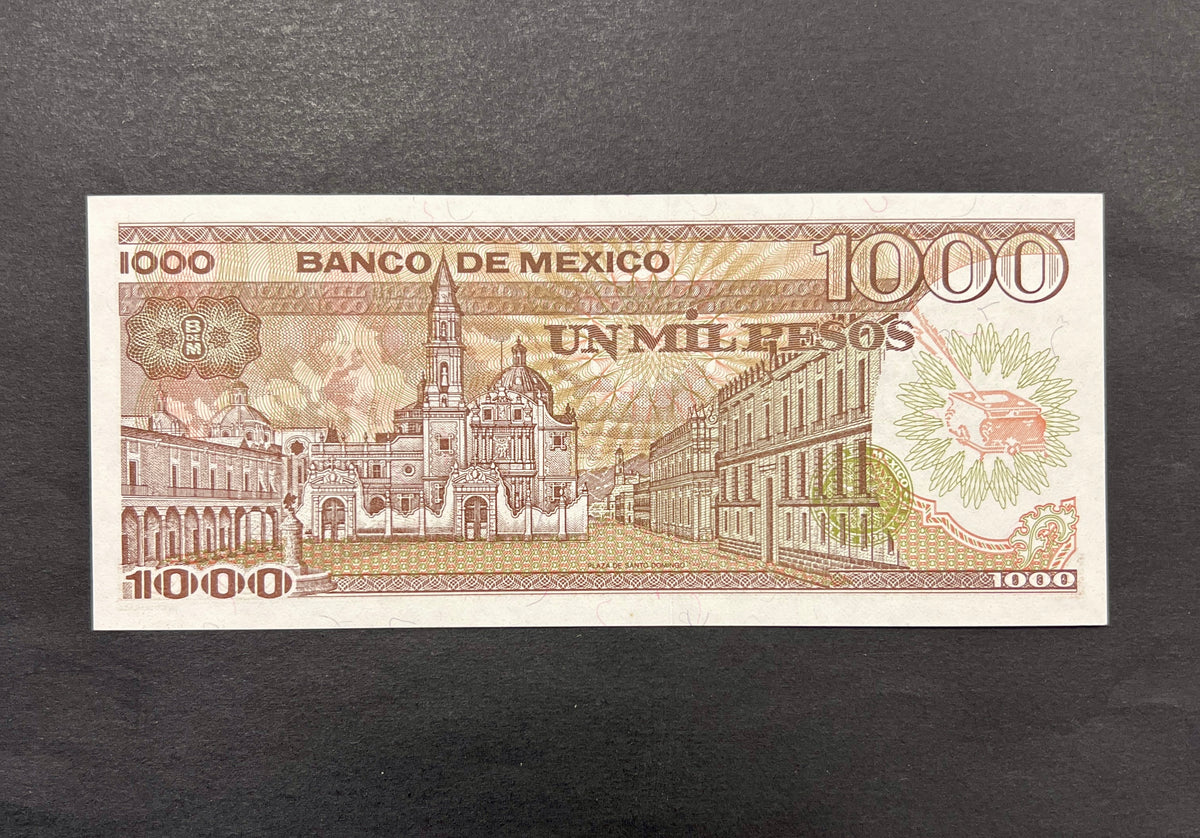 Back view of a 1985 Mexico 1000 Pesos banknote showcasing a detailed vintage engraving of the historic Plaza de Santo Domingo in Mexico City.