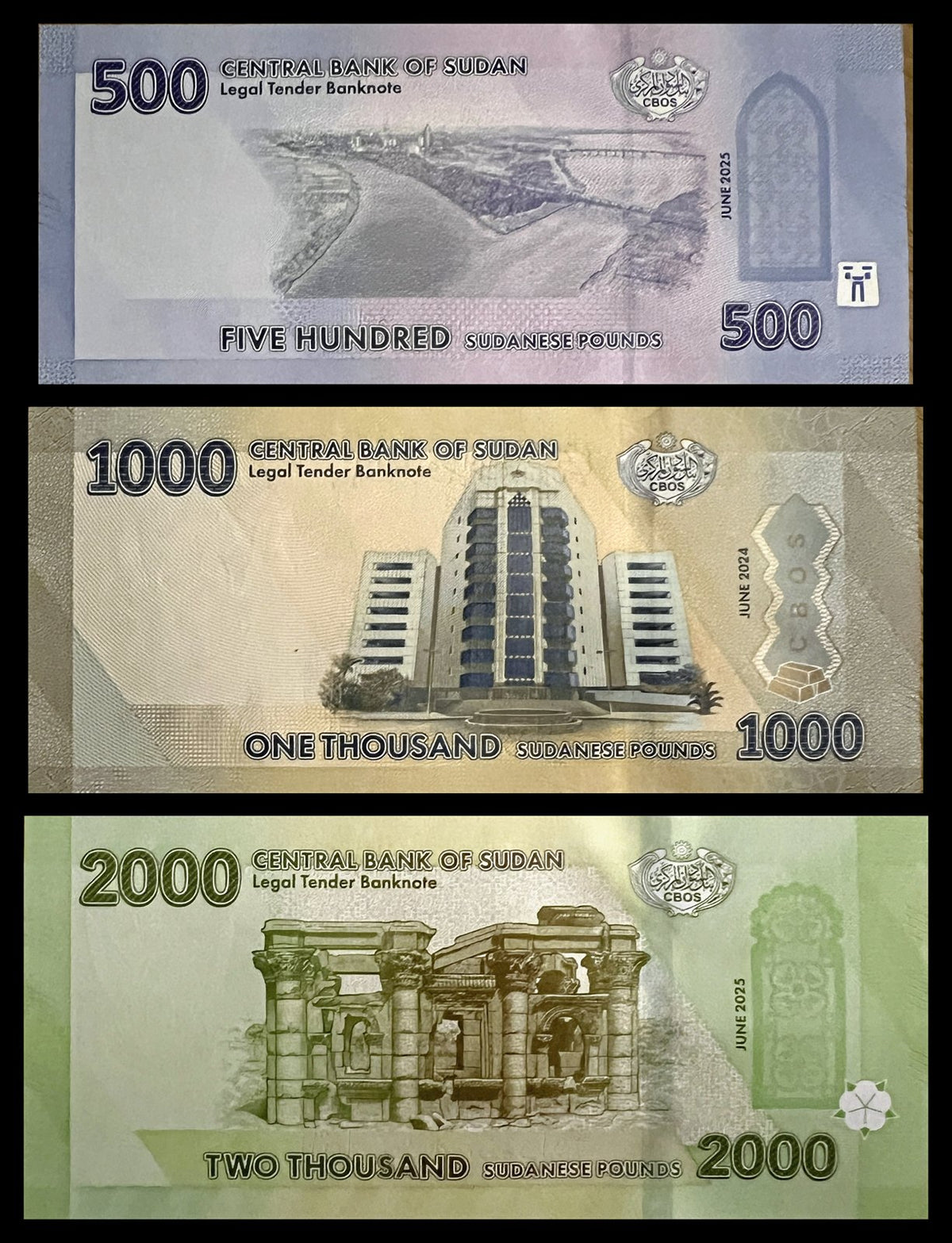 Back view of a Sudan 500, 1000 and 2000 Pounds set showing the Al-Mogran confluence of the Blue and White Nile, the Central Bank of Sudan headquarters and the Roman Kiosk at Naqa.