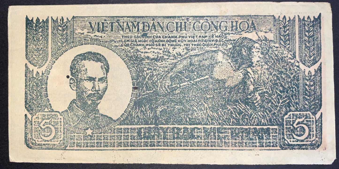 Obverse of an authentic Vietnam 5 Dong 1948 P-17a3 banknote featuring a portrait of Nguyễn Ái Quốc (Ho Chi Minh), a farmer harvesting rice, ornate geometric borders, and the 5 Đồng denomination.