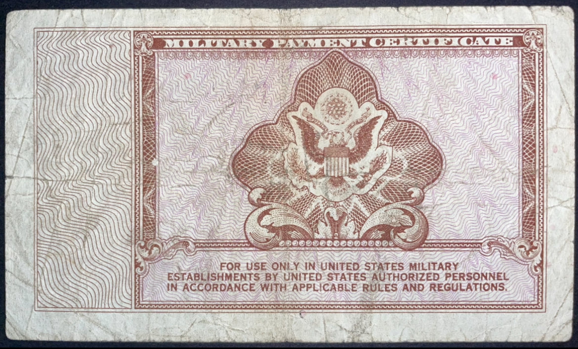 Reverse of a US Military Payment Certificate 1 Dollar, Series 472, featuring the American eagle emblem within an ornate brown engraved design