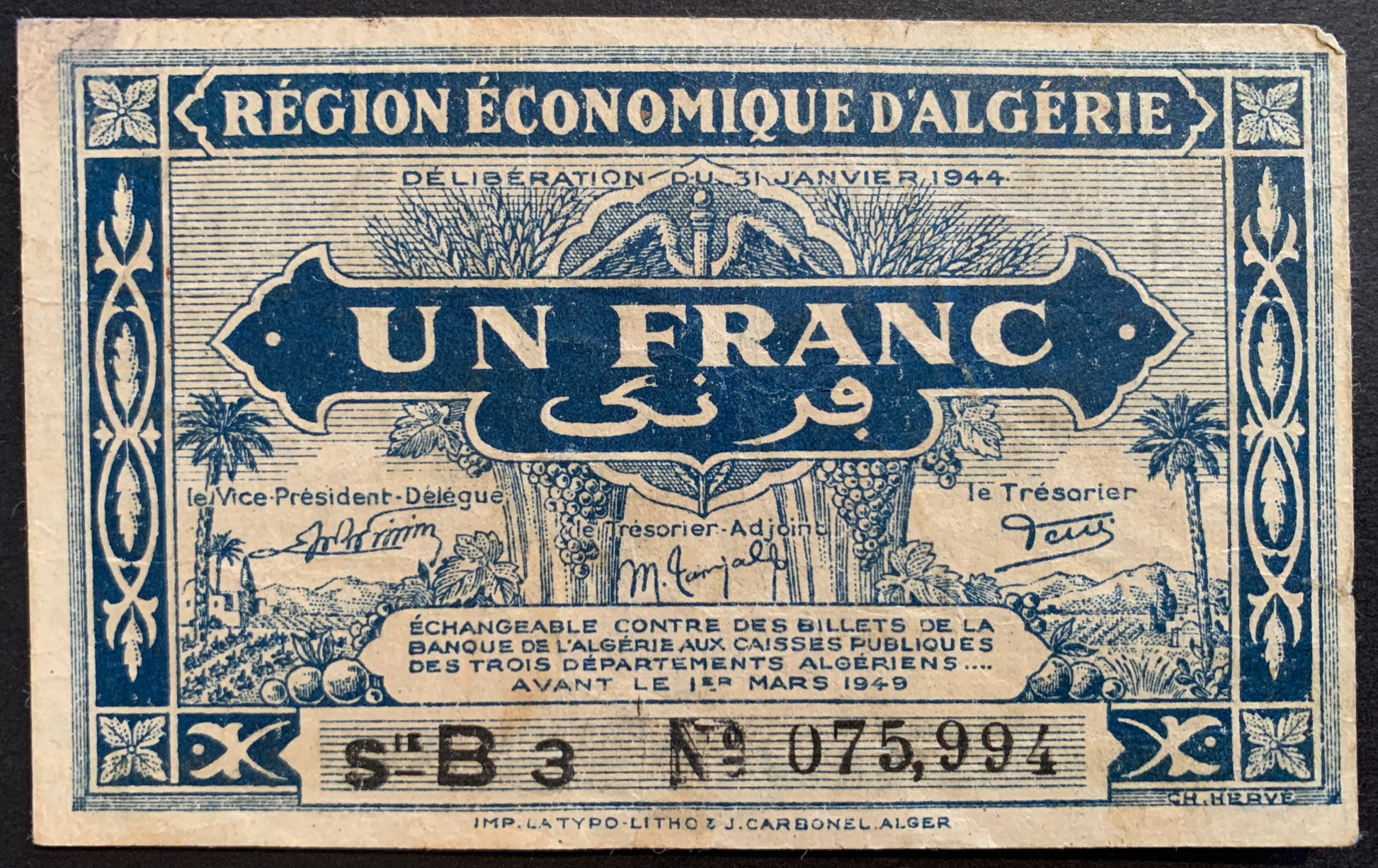 front of Algeria 1 Franc 1944 P-98a collectible vintage banknote with floral frame; country scene represented by palm trees, fruits, a sheaf of wheat, an agricultural field and a village in the distance