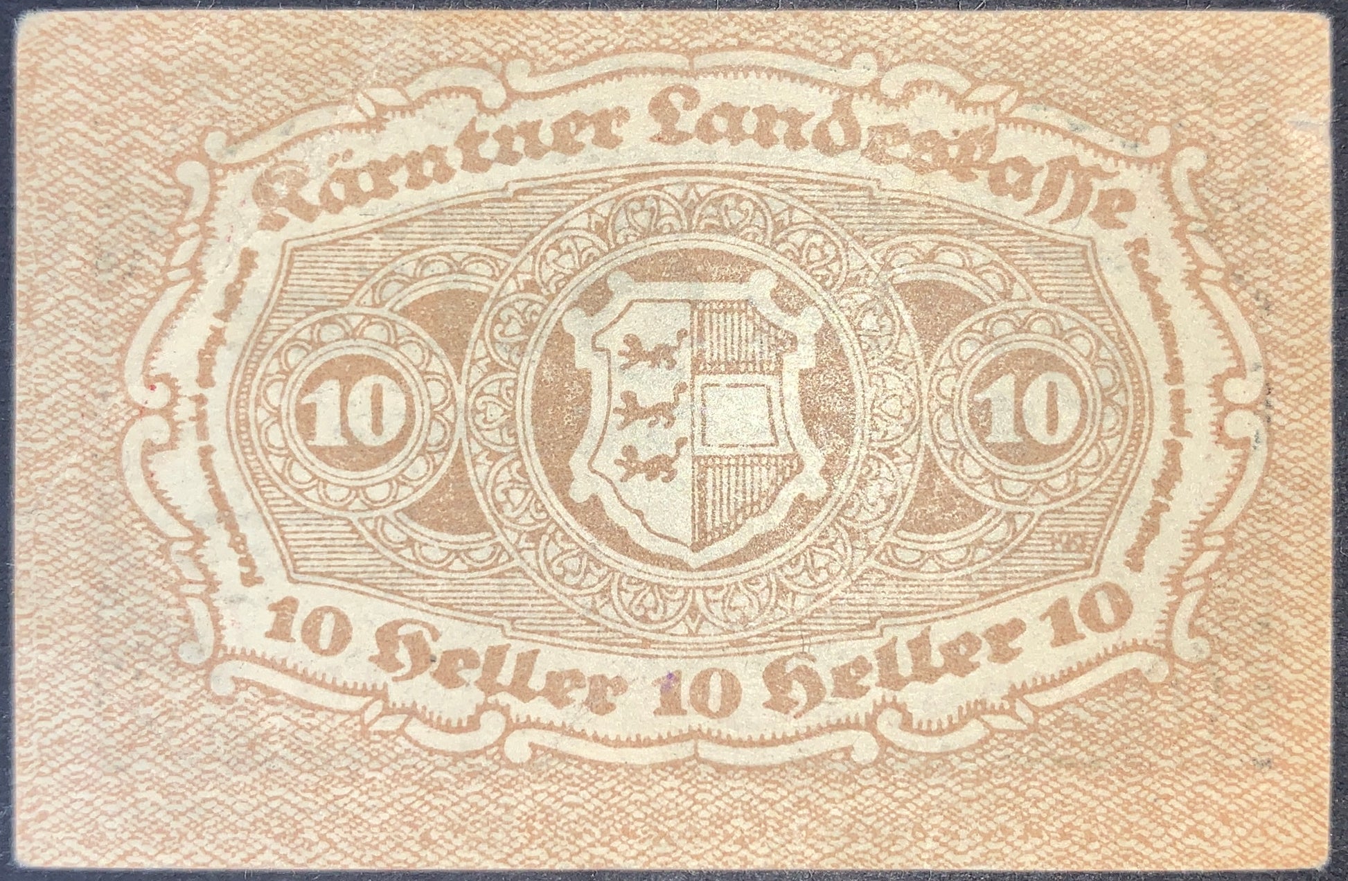 Austria Carinthia 10 Heller 1920 notgeld banknote reverse showing decorative coat of arms, denomination medallions, and intricate geometric engraving patterns