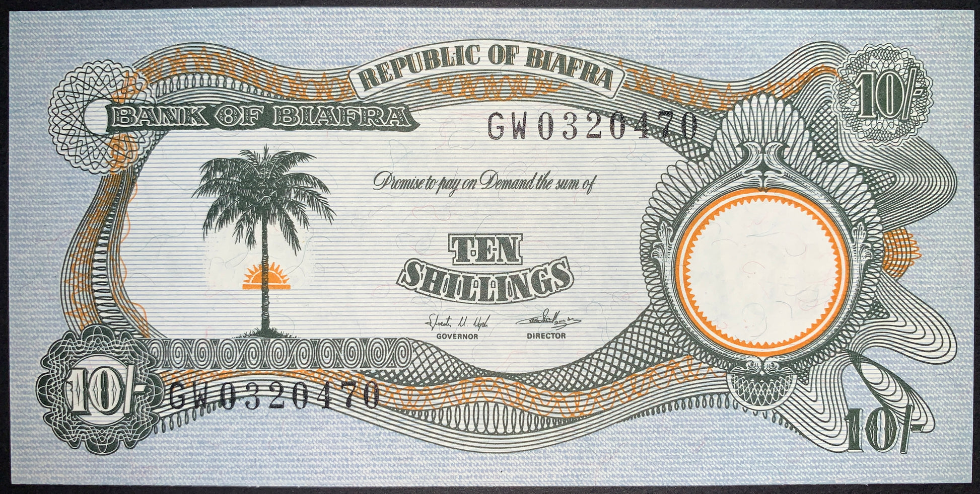 Obverse of the authentic Biafra 10 Shillings banknote ND (1968–1969) P-4 featuring a palm tree with a rising sun, intricate guilloche patterns, Republic of Biafra inscription, serial number, and engraved security details.
