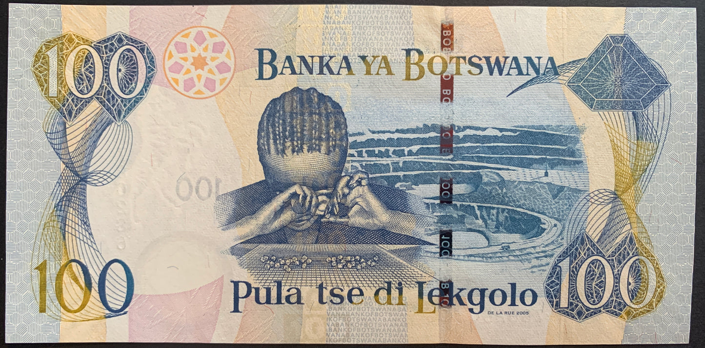 back of Botswana 100 Pula 2005 P-29b UNC collectible african banknote with person sorting diamonds and diamon mine