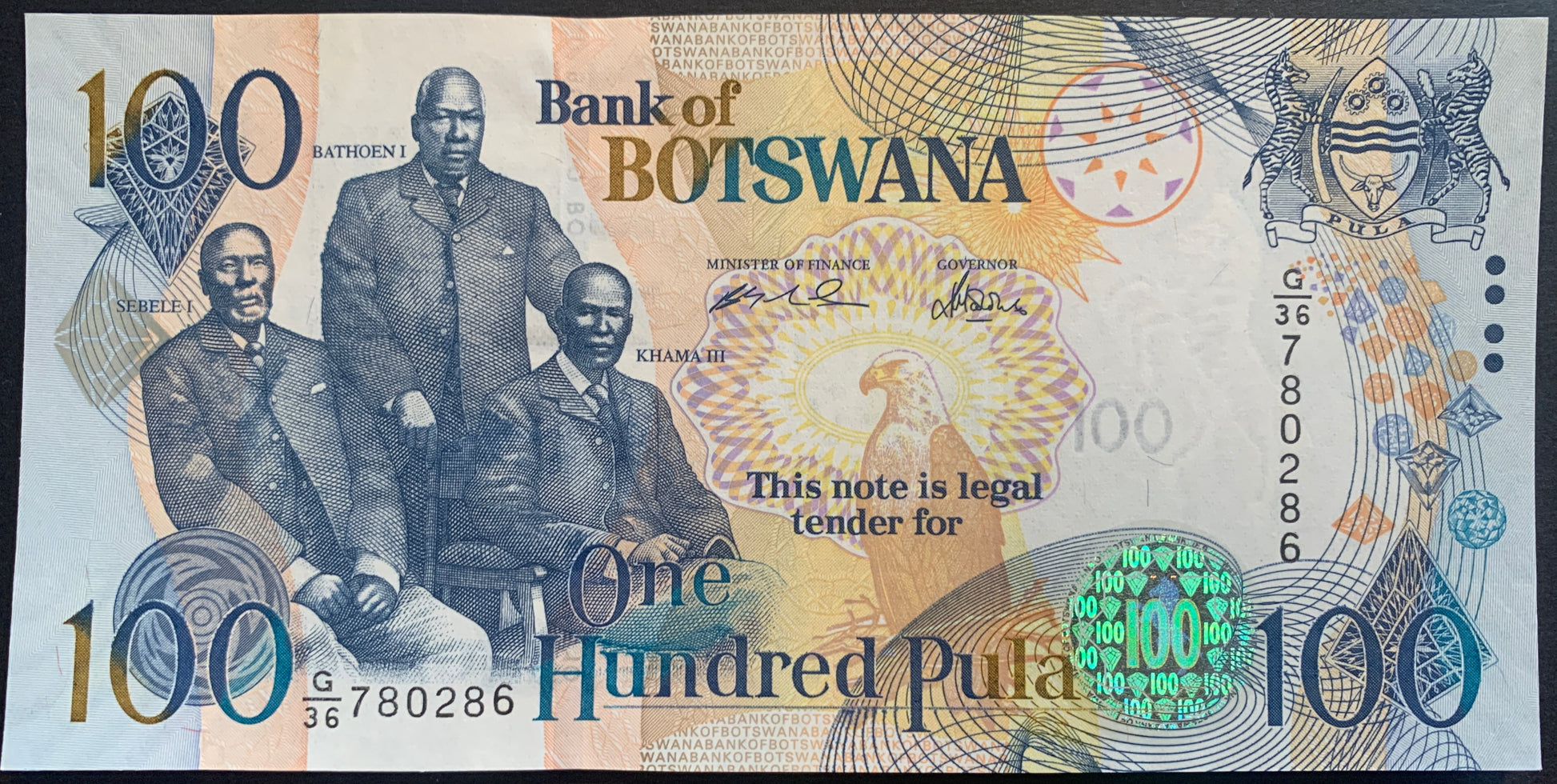 front of Botswana 100 Pula 2005 P-29b UNC collectible banknote with fish eagle and the three chiefs Sebele I, Bathoen I, Khama III