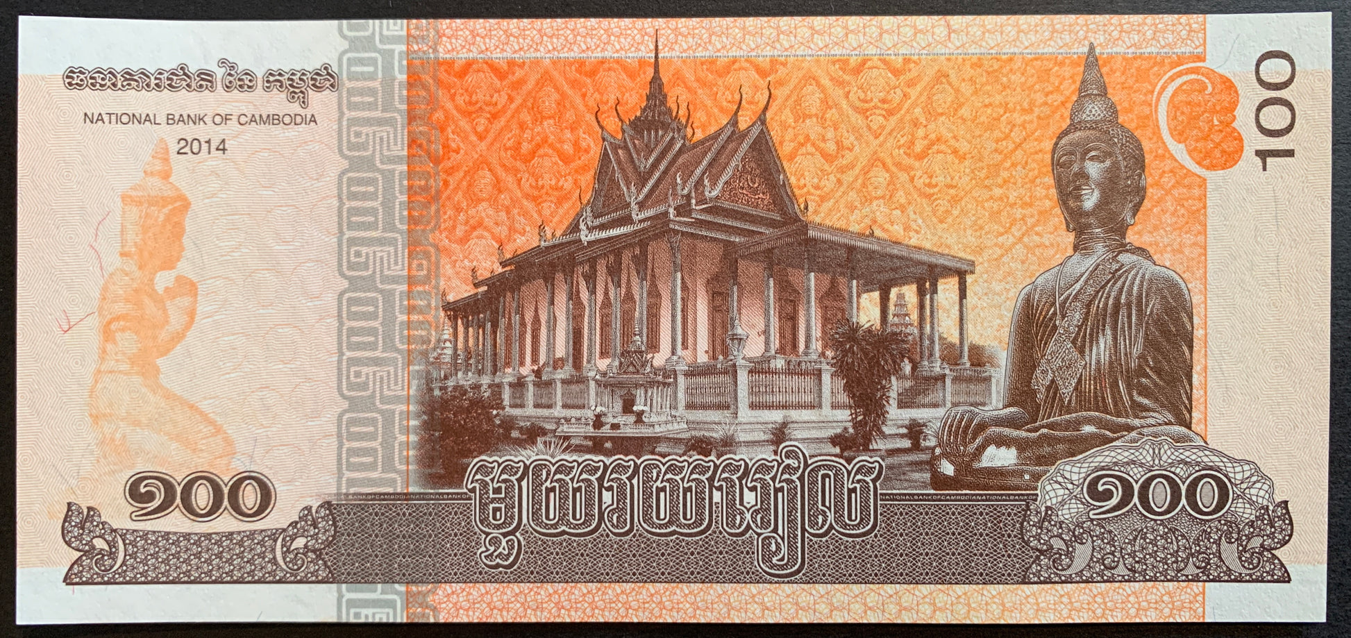 Cambodia 100 Riels 2014 P-65 banknote with Buddha statue, Wat Preah Keo temple, and Khmer statue