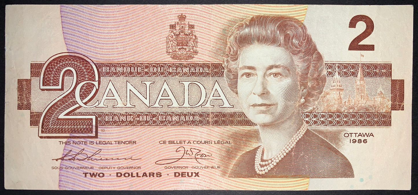 front of Canada 2 Dollars 1986 P-94 F collectible vintage banknote with portrait of Queen Elizabeth II