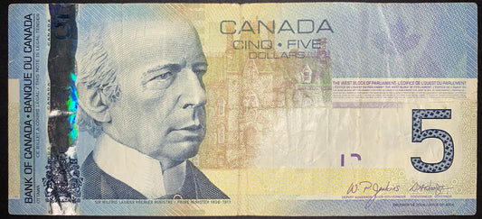 Obverse view of a 2006 Canadian 5-dollar banknote from the Canadian Journey series featuring a portrait of Sir Wilfrid Laurier. The bill includes a prominent vertical holographic security stripe on the left side displaying shifting colors, maple leaves, and the numeral 5. The design features a large patterned numeral 5 on the bottom right, an illustration of the West Block of Parliament in the background, and the signatures of Deputy Governor W.P. Jenkins and Governor David Dodge.