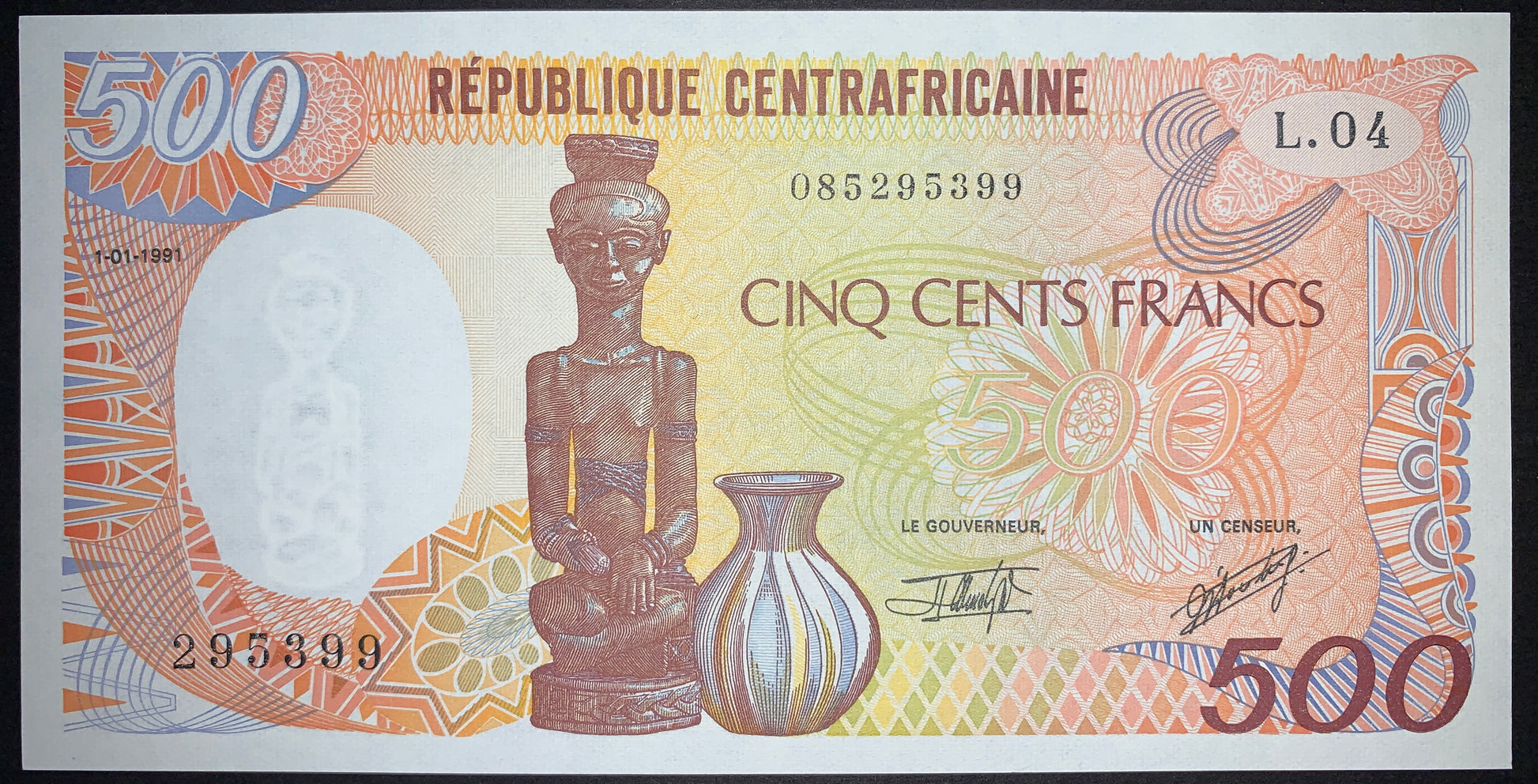 Obverse of the Central African Republic 500 Francs 1991 P-14d UNC banknote displaying a finely carved ancestral wooden figure holding an offering bowl, a handcrafted ceramic vase, colorful geometric patterns, and a statue watermark. Authentic uncirculated CFA Franc collectible.