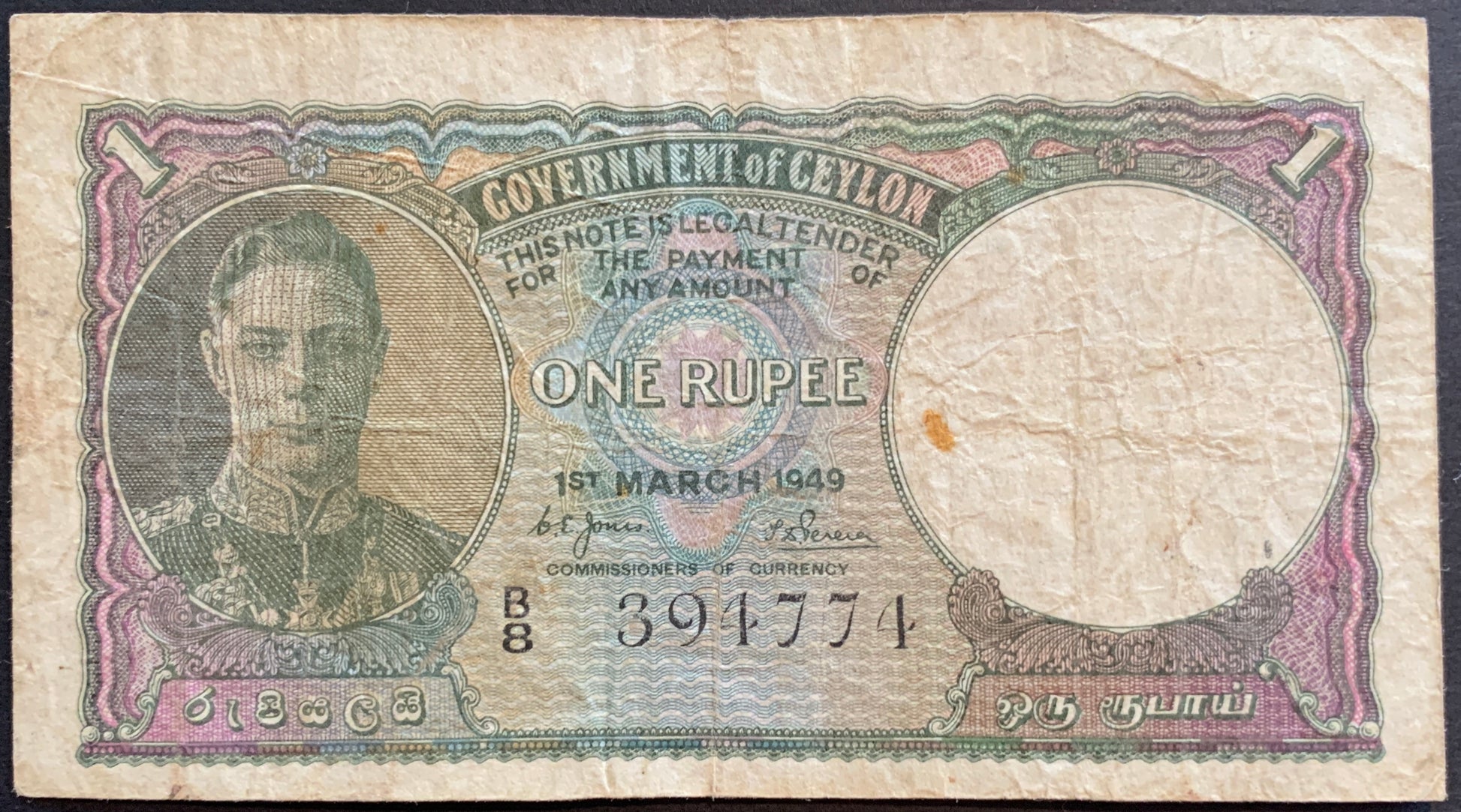 Obverse of Ceylon 1 Rupee 1949 P-34 banknote showing King George VI portrait with ornate green colonial-era design.