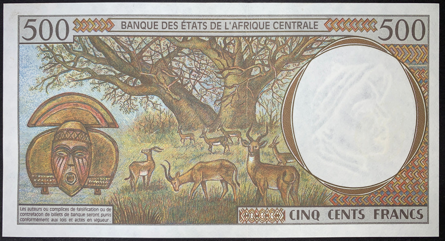 Reverse of the Chad 500 Francs 2000 P-601Pg UNC banknote featuring a giant baobab tree, antelopes running across the savannah, a traditional Kota tribal mask, and a three-antelope-head watermark. Authentic uncirculated BEAC collectible banknote.