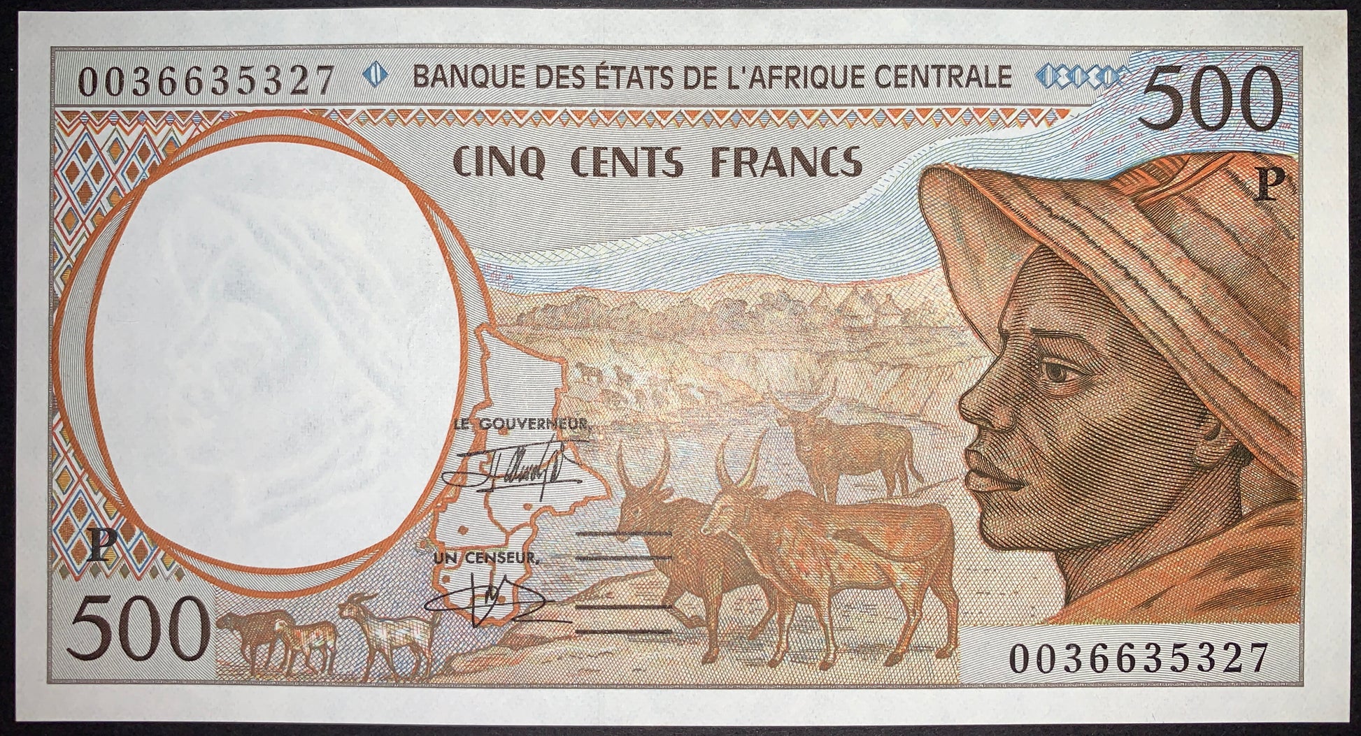 Obverse of the Chad 500 Francs 2000 P-601Pg UNC banknote showing a Central African shepherd, grazing Zebu cattle, a map of the Central African States, and a watermark of three translucent antelope heads. Authentic BEAC CFA Franc banknote.