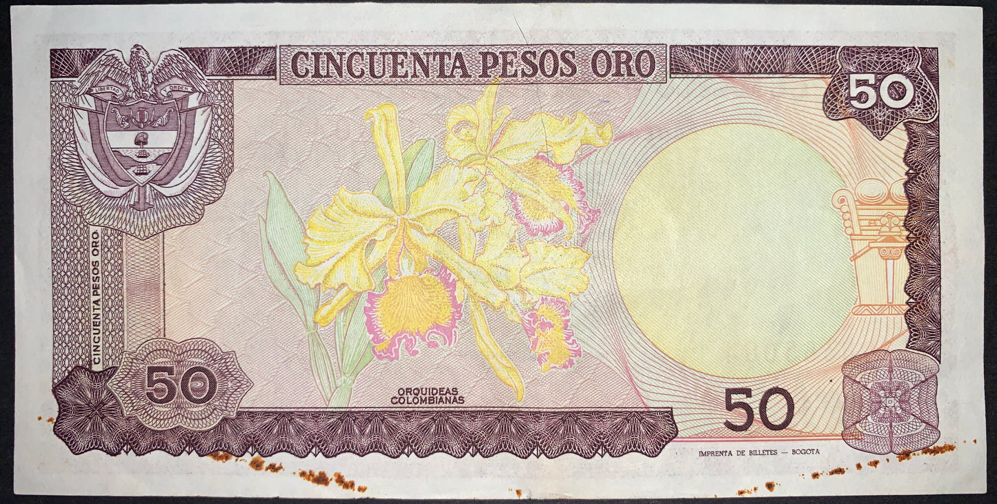 back of Colombia 50 Pesos Oro 1984 P-425a F collectible vintage banknote with Colombian orchids (Mayflower Cattleya trianae), the national flower and the Coat of Arms of Colombia