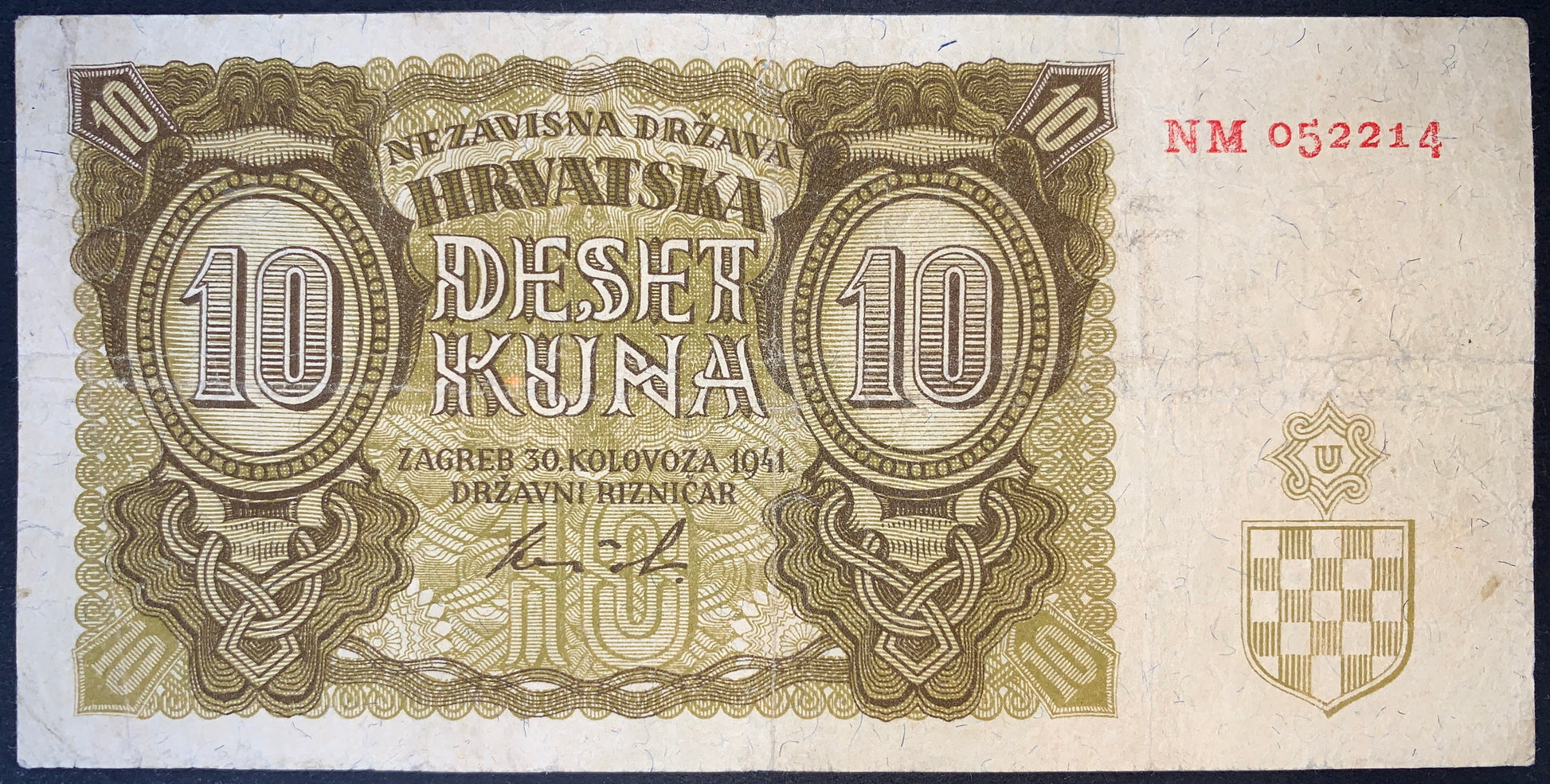 Croatia 10 Kuna 1941 banknote obverse featuring ornate oval denomination panels, Croatian coat of arms, red serial number, and detailed engraved border patterns