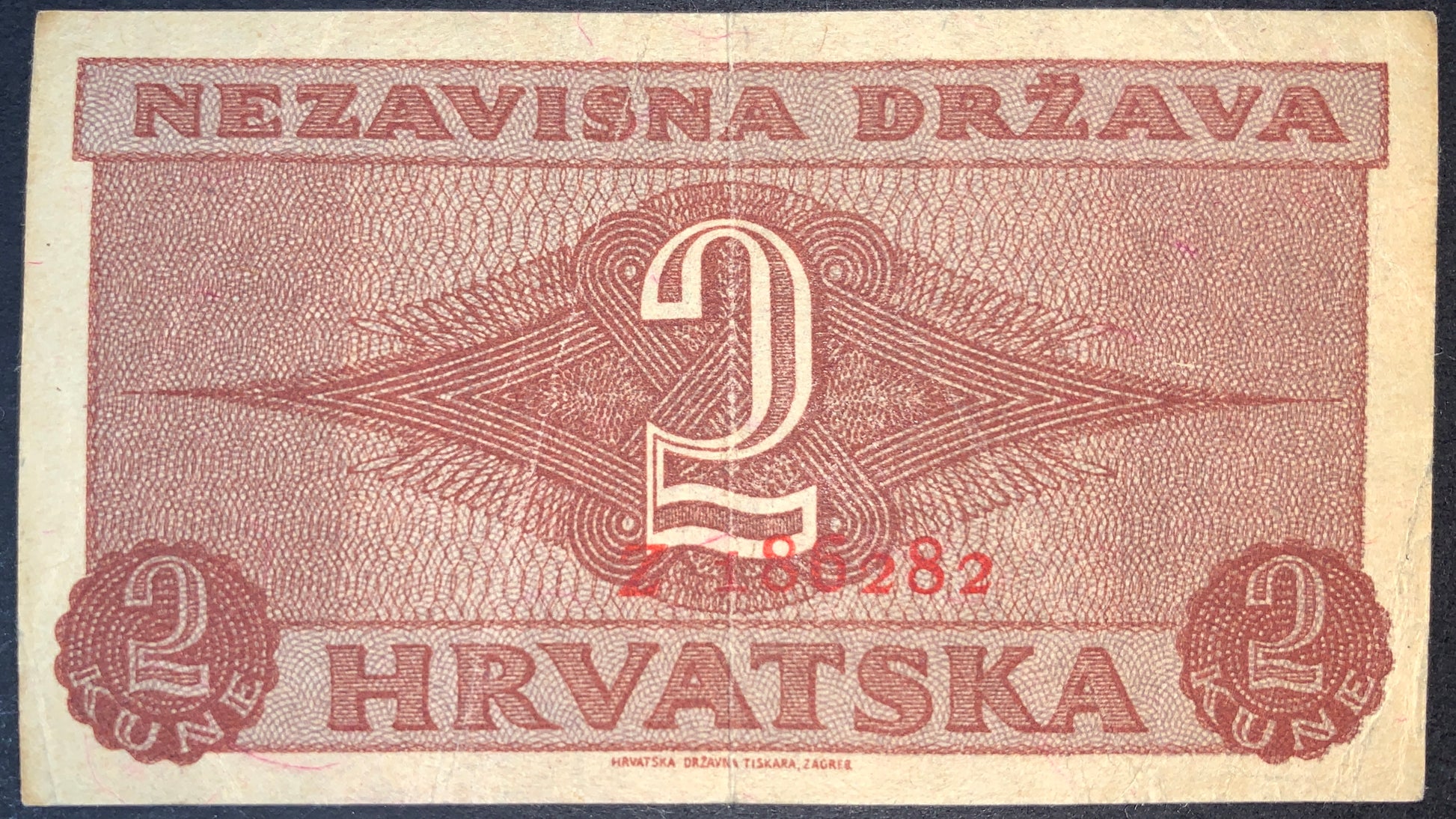 Reverse of Croatia 2 Kune 1942 banknote featuring large numeral 2, decorative geometric security design, and Hrvatska inscription from the wartime Croatian issue