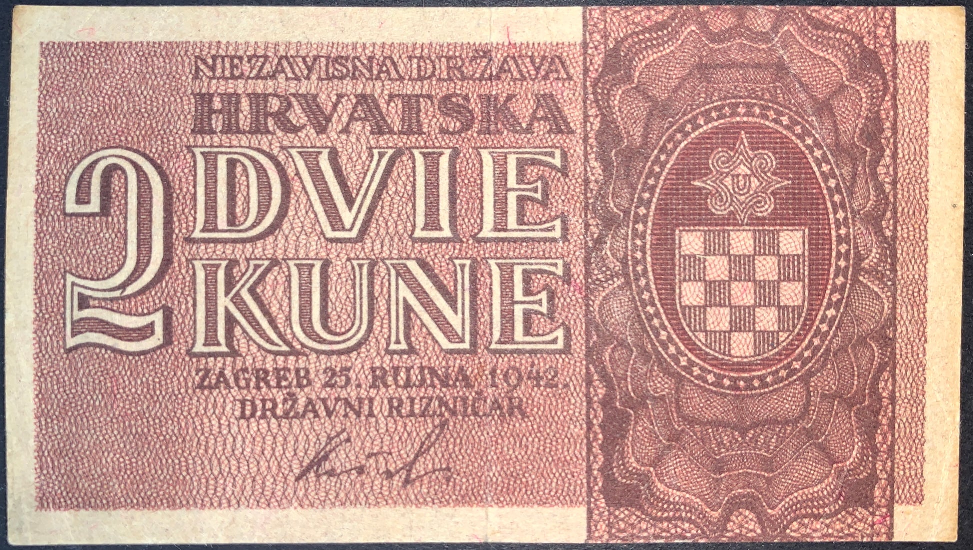 Croatia 2 Kune 1942 banknote obverse with large denomination lettering, Croatian checkerboard coat of arms, fine engraved patterns, and Independent State of Croatia inscription