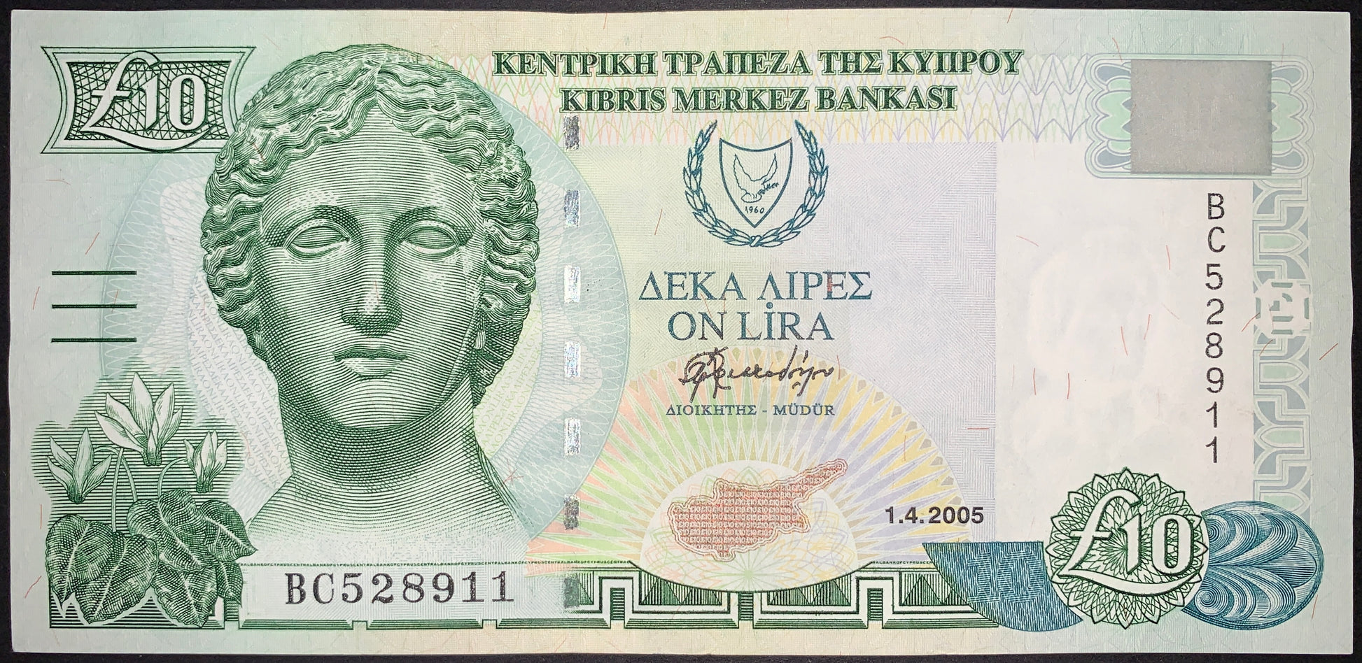 Cyprus 10 Pounds banknote dated 1 April 2005, featuring a classical female sculpture portrait, Cyprus national emblem, map of Cyprus, intricate security patterns, and multilingual inscriptions from the Central Bank of Cyprus.