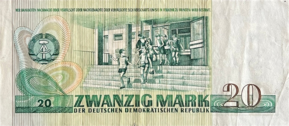 Back view of a 1975 East Germany 20 Mark banknote showing schoolchildren running down the steps of a modern school.
