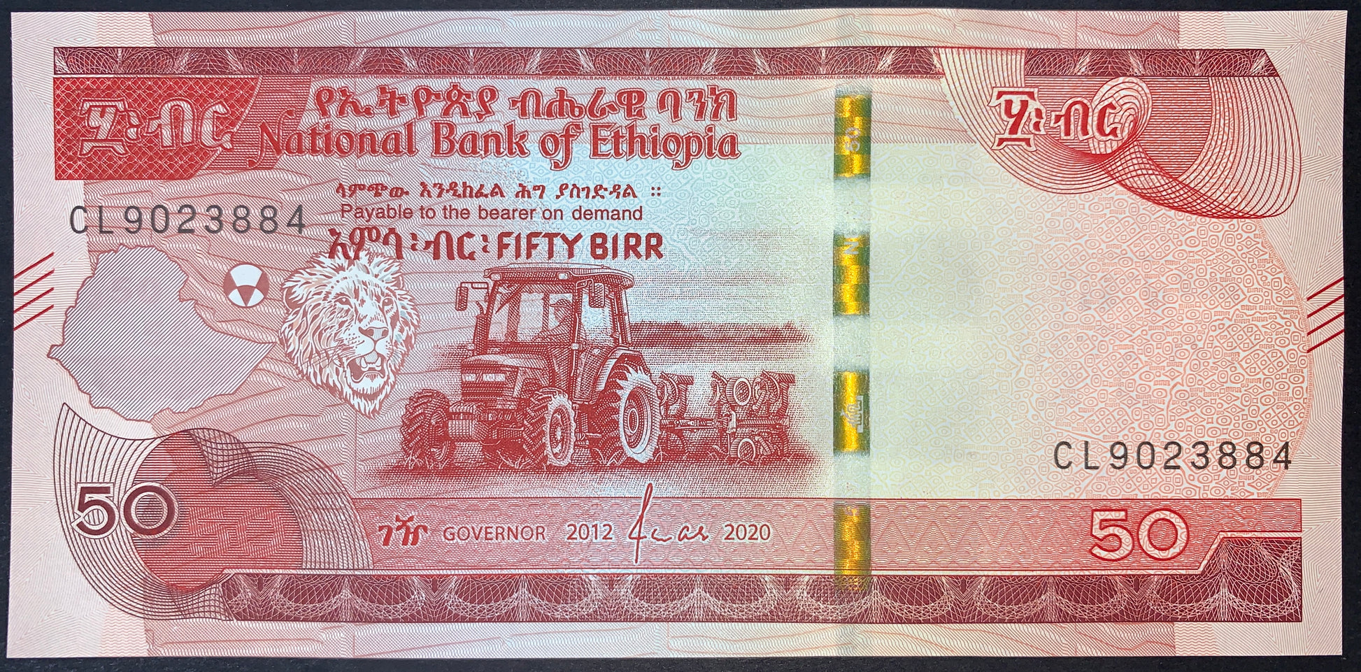 front of Ethiopia 50 Birr 2012 (2020) collectible modern african banknotes with Lion of Judah, tractor, and map of Ethiopia