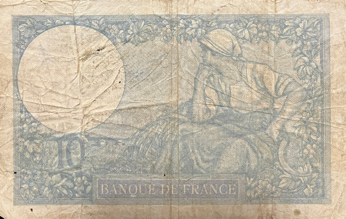 Back view of a 1941 France 10 Francs banknote showing a young peasant woman with a sickle and wheat sheaf among vines.