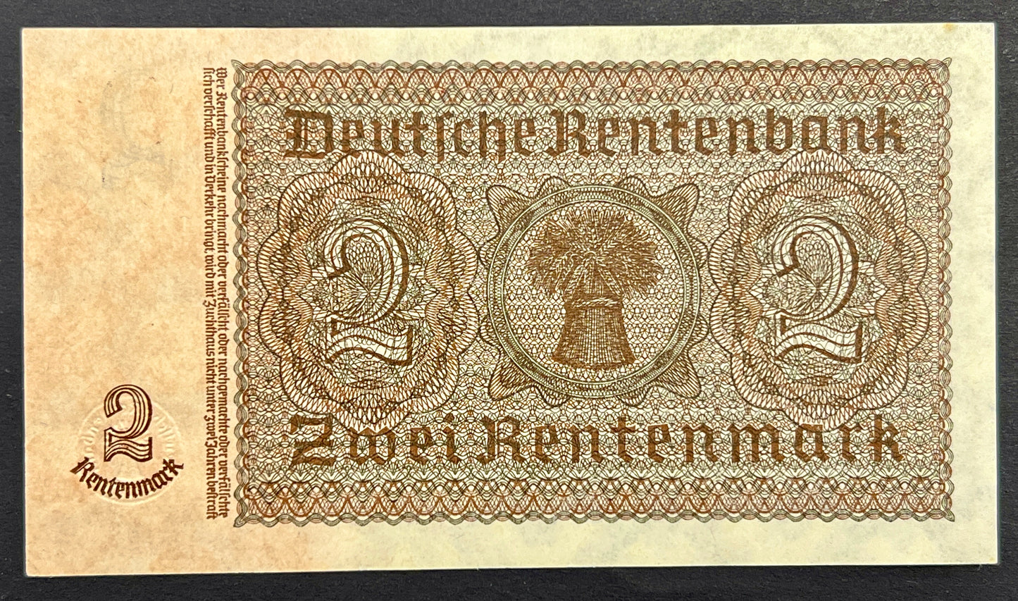 A vintage German Rentenbank 2 Rentenmark banknote with ornate brown printed details on aged beige paper, shown against a dark background.