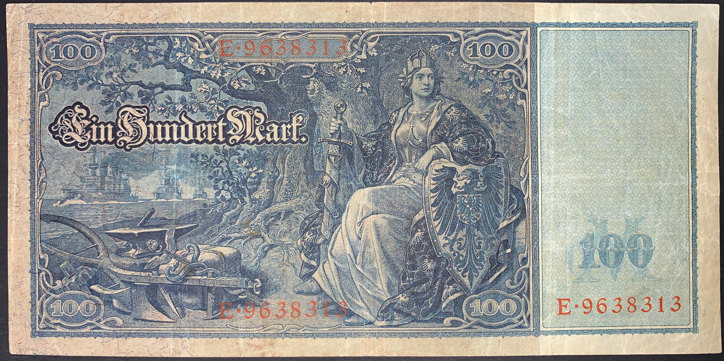 back of  Germany 100 Mark 1910 P-42 F collectible vintage banknote with Germania seated beneath an oak tree, the Imperial Fleet in the background
