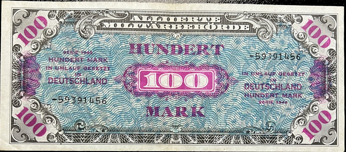 Front view of a 1944 Allied Military Currency 100 Mark banknote with a bold violet 100, Hundert Mark text and a dash-prefixed serial number on a blue wavy underprint.