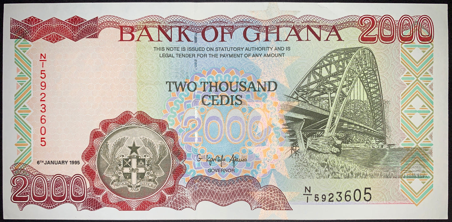 front of Ghana 2000 Cedis 1995 P-30b UNC collectible vintage african banknote with Adomi Bridge over Volta River