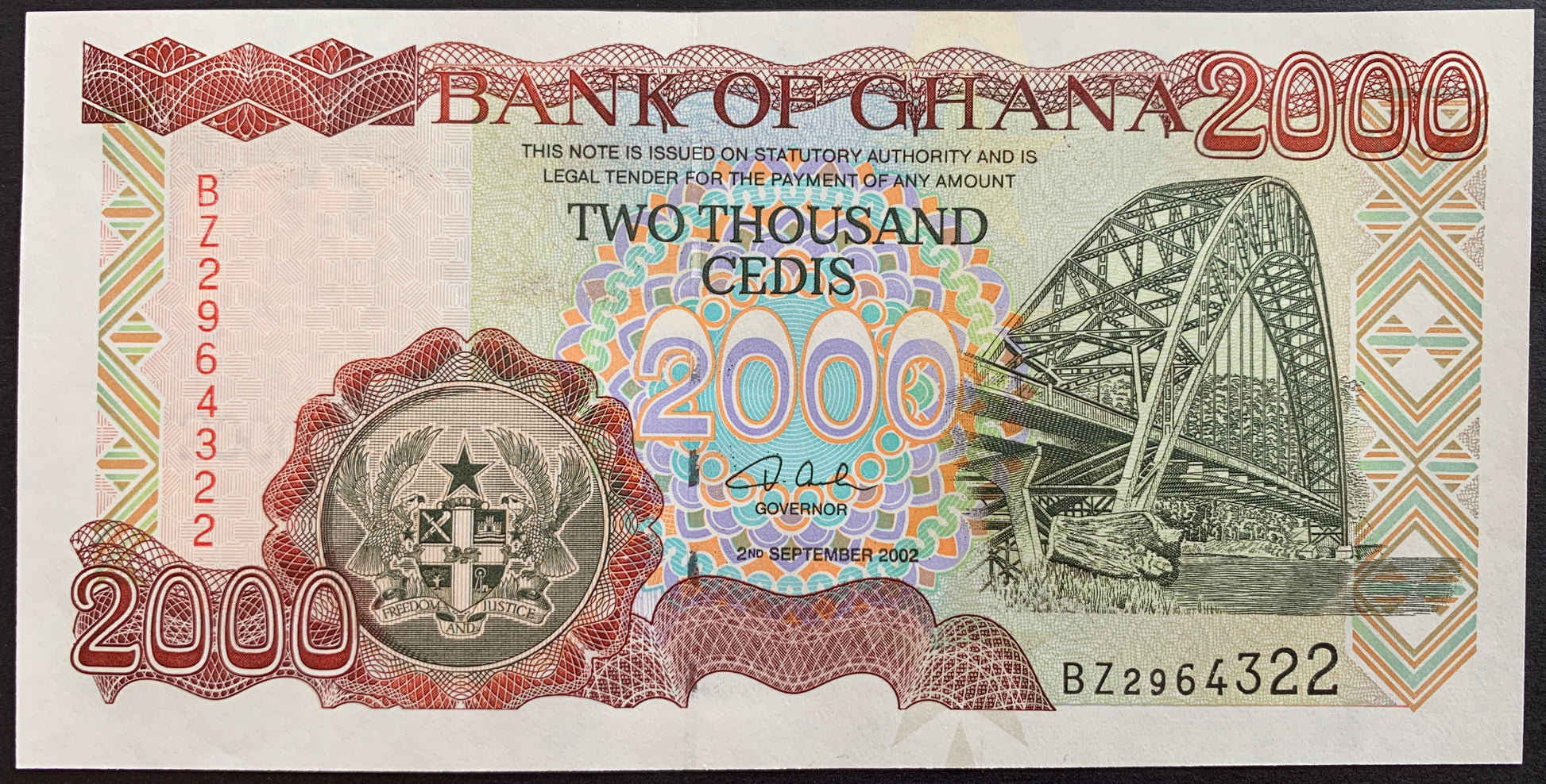 front of Ghana 2000 Cedis 2002 P-33g colelctible banknote with Adomi Bridge over Volta River