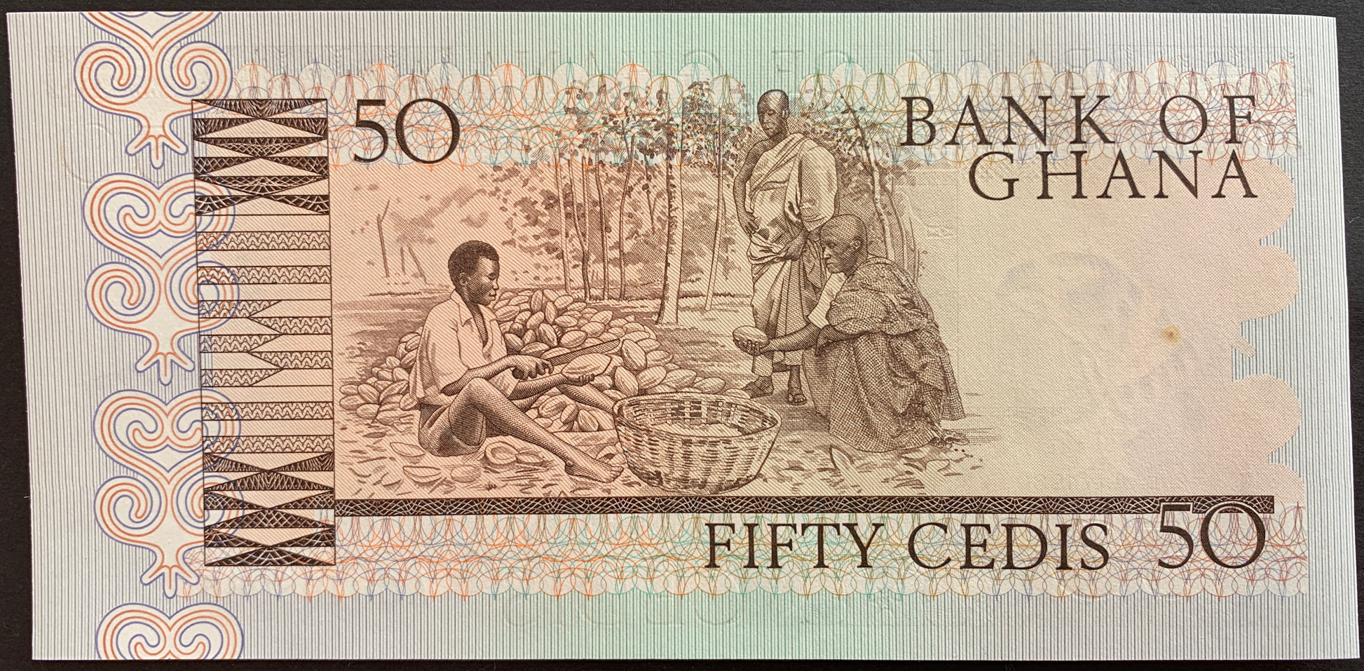 back of Ghana 50 Cedis 1980 P-22b collectible banknote with men splitting cacao pods