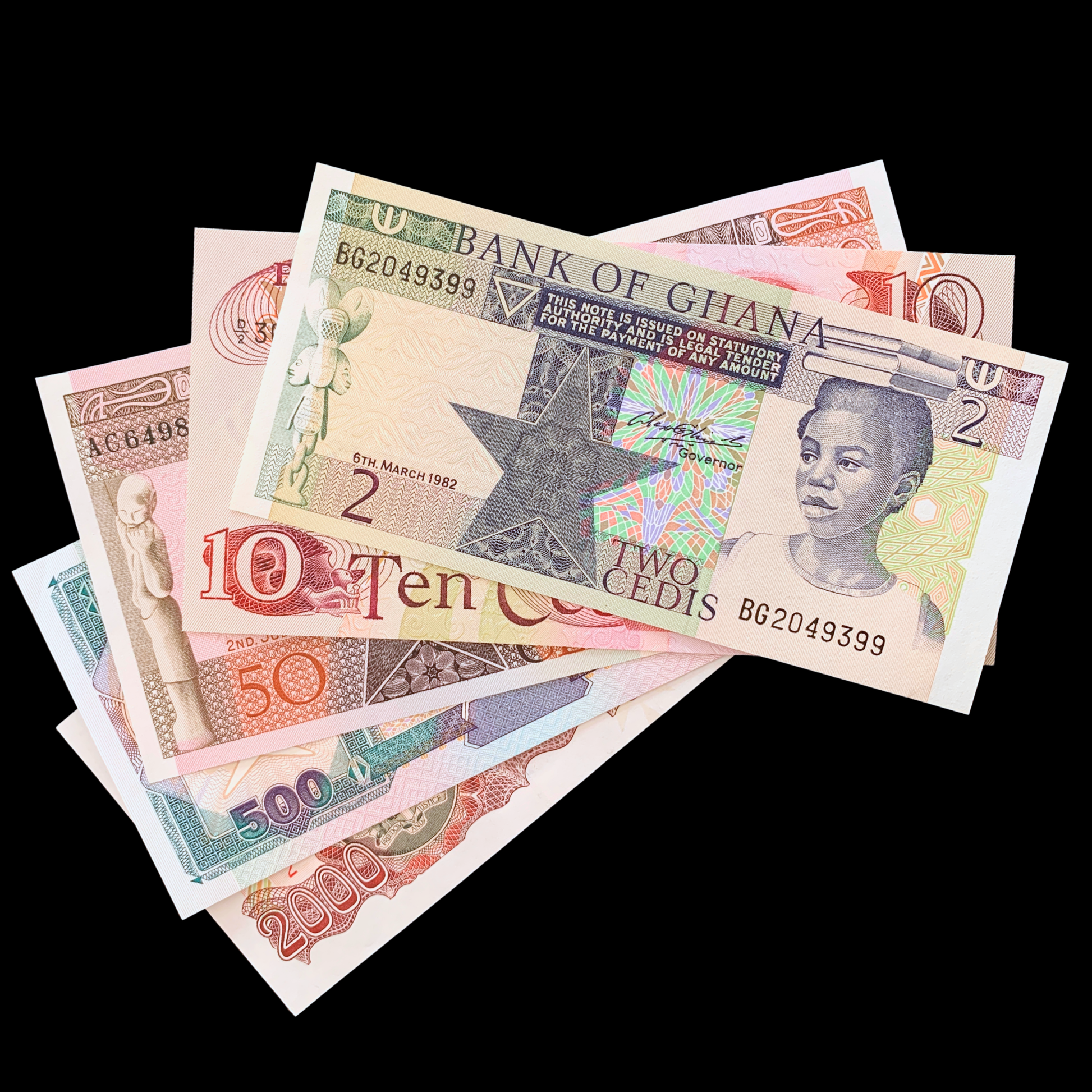 bundle of Ghanaian Second Cedi banknotes on black background