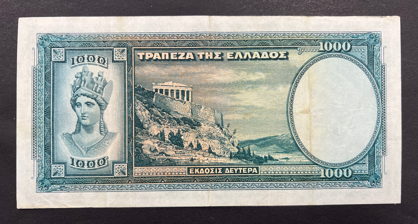 Back view of a circulated 1939 Greece 1000 Drachmai banknote showcasing a detailed engraving of the Acropolis of Athens and a classical bust of the goddess Athena.
