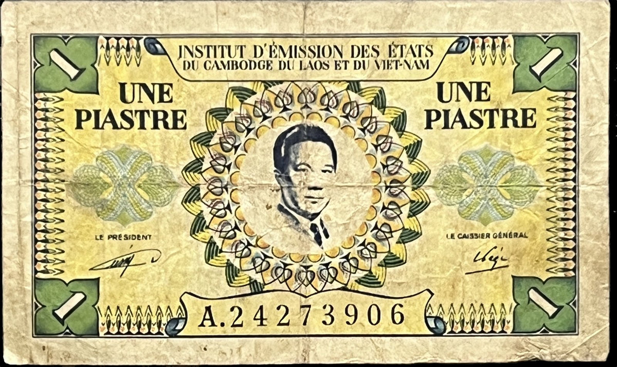 Front view of a circulated 1953 French Indochina 1 Piastre banknote featuring a portrait of Bảo Đại, the last emperor of Vietnam, inside an ornate rosette.