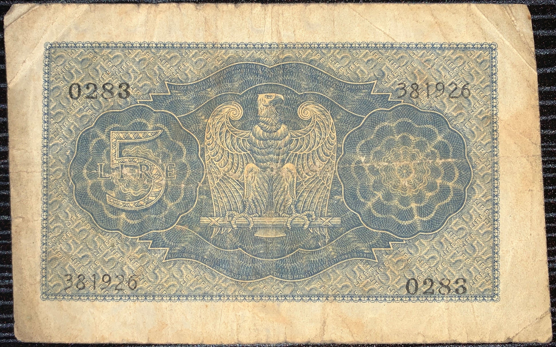 back of Italy 5 Lire 1940 P-28 F collectible vintage wwii era banknote with eagle clutching a sword