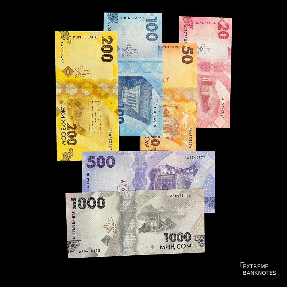 Back view of six 2023 Kyrgyzstan banknotes showing Tash Rabat caravanserai, the Uzgen minaret, Kurpsay dam, a poem on Issyk-Kul and Sulaiman-Too.