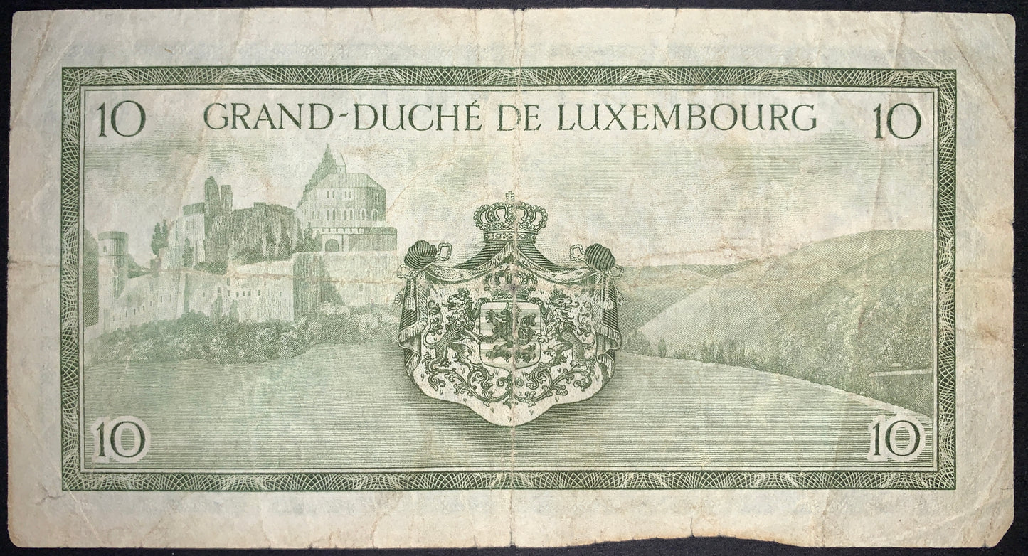 back of Luxembourg 10 Francs ND (1954) P-48 VG collectible vintage banknote with Vianden Castle and national coat of arms