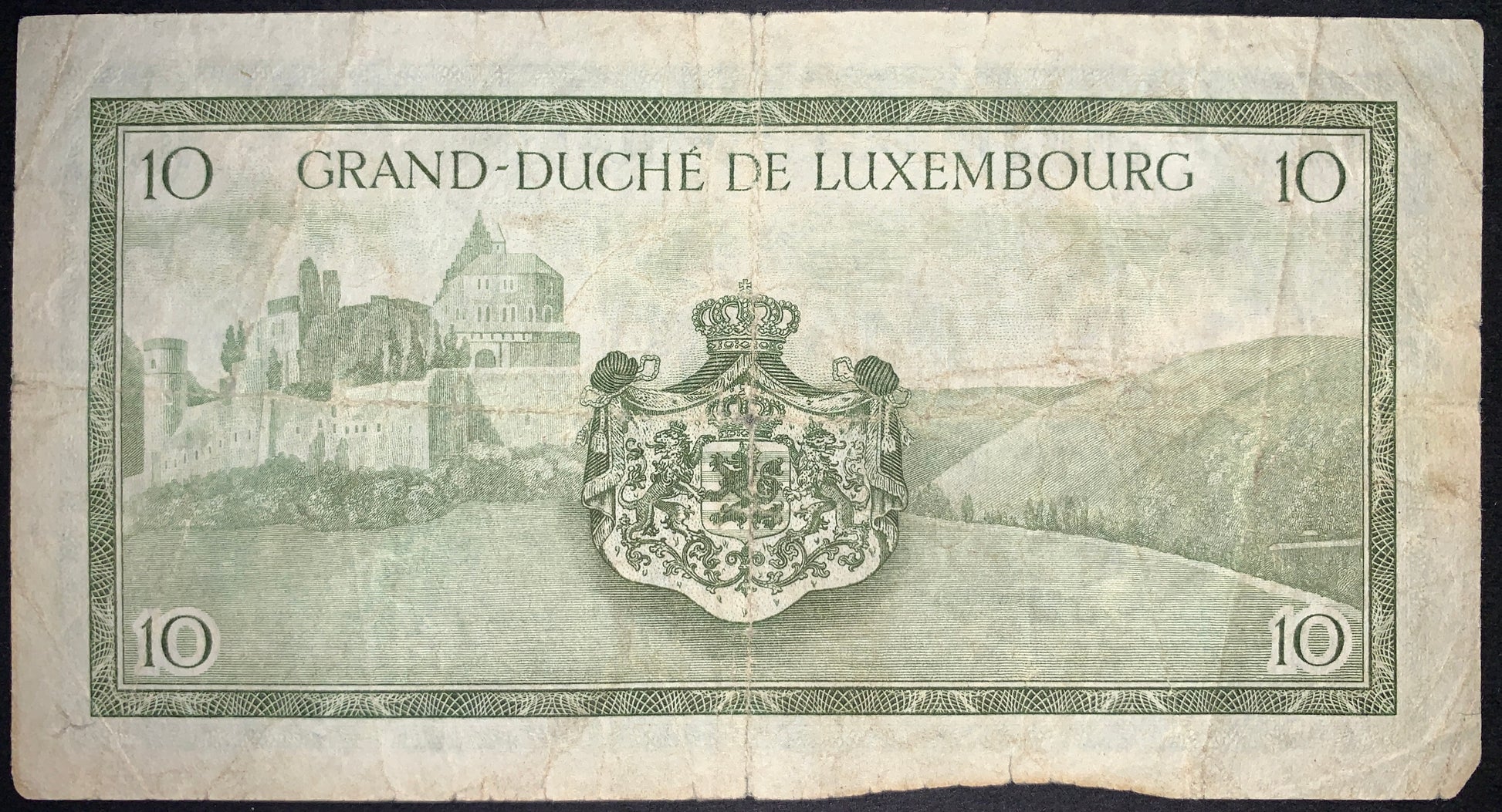 back of Luxembourg 10 Francs ND (1954) P-48 VG collectible vintage banknote with Vianden Castle and national coat of arms