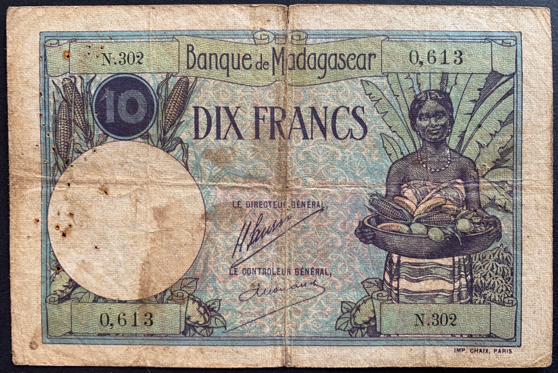 front of Madagascar 10 Francs ND (1926-1937) P-36a F+ african collectible vintage banknote with ears of corn and young woman with basket of fruits and cereals with a Ravinala (traveler's tree)