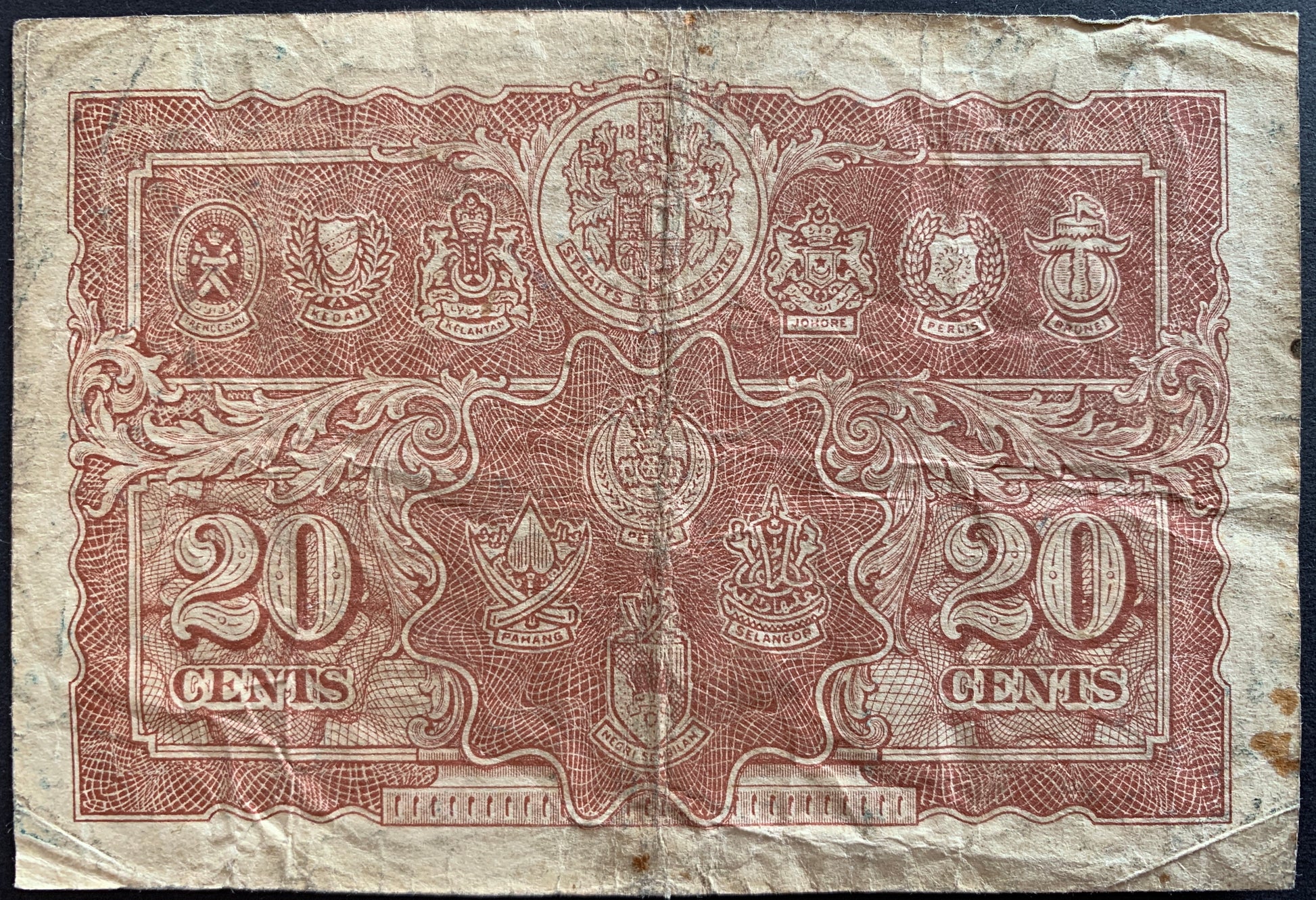 back of Malaya 20 Cents 1941 P-9 VF collectible vintage banknote with the coat of arms of the Straits Settlements, Trengganu, Kedah, Kelantan, Johore, Perlis, Brunei, Perak, Pahang, Selangor and Negri Sembilan