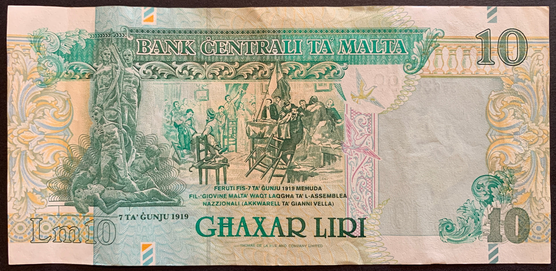 Malta 10 Liri ND (1997-1999) P-47b VF collectible pre-euro banknote with "7th June 1919" Monument at left, Wounded people brought into the National Assembly on 7th June 1919 (painting by Gianni Vella)