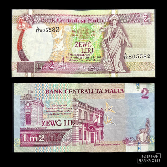 Front view of a circulated 1989 Malta 2 Liri banknote featuring the allegorical figure of Melita holding a ship's rudder and the Maltese coat of arms. Back view of a vintage 1989 Malta 2 Liri banknote showcasing detailed engravings of the historic Banca Giuratale buildings in Mdina and Gozo.