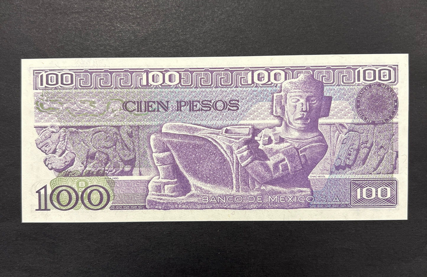 Back view of a 1982 Mexico 100 Pesos banknote showcasing a detailed engraving of the ancient Chac Mool stone sculpture.
