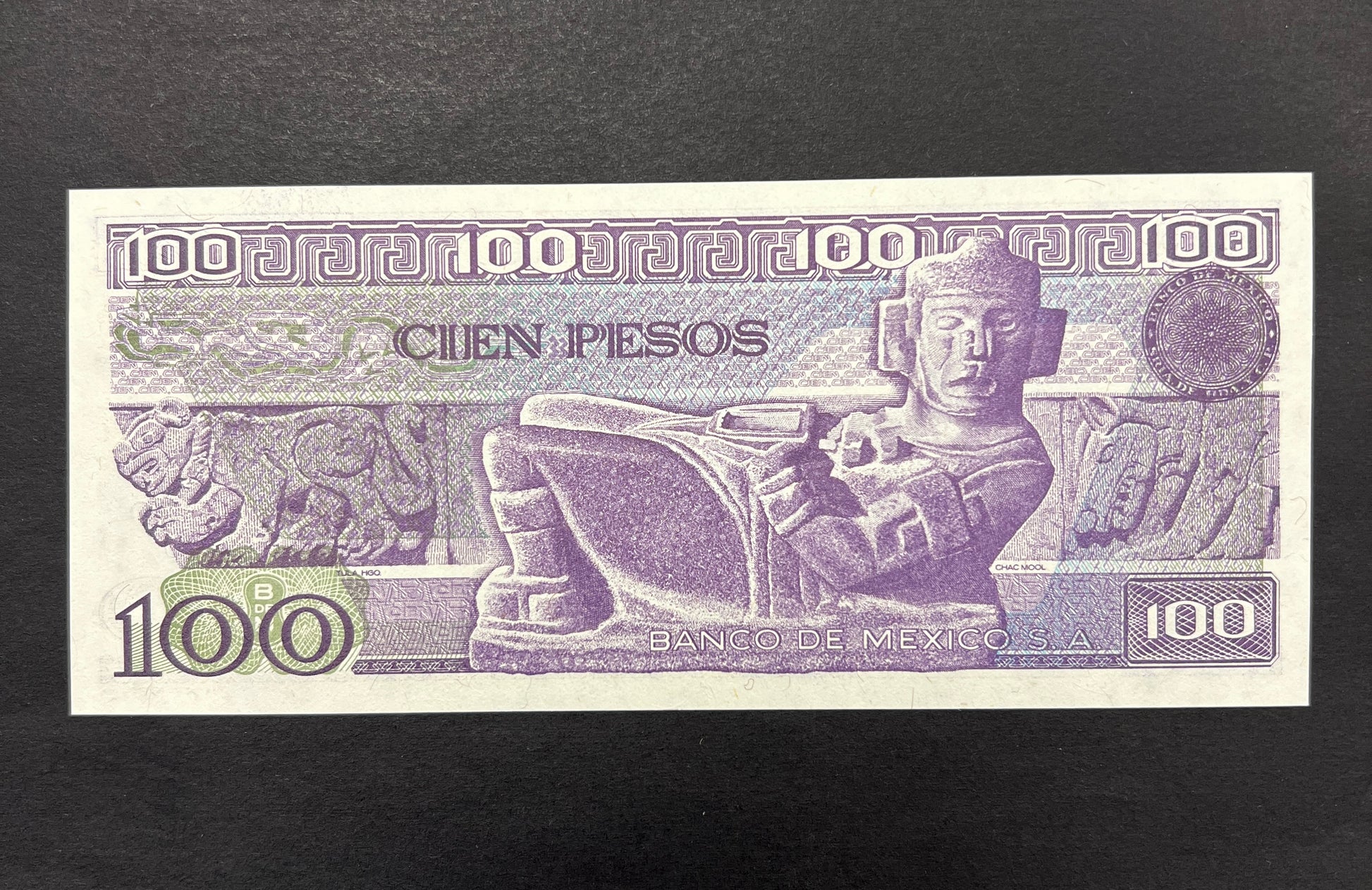 Back view of a 1982 Mexico 100 Pesos banknote showcasing a detailed engraving of the ancient Chac Mool stone sculpture.
