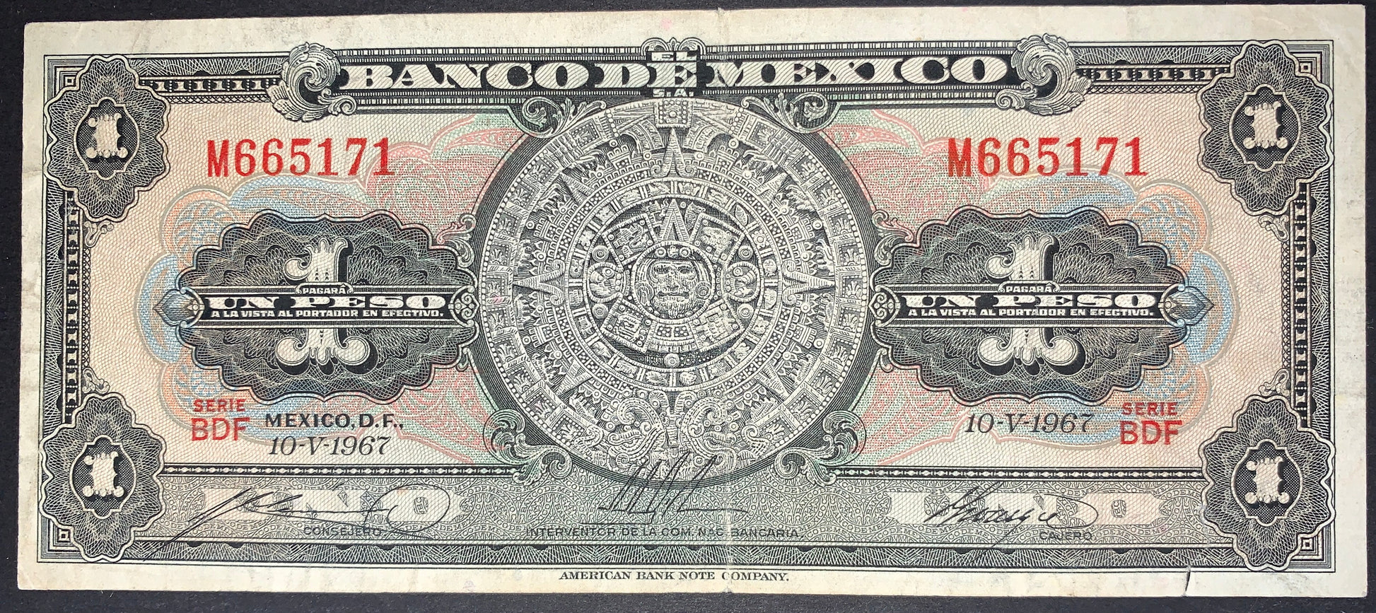 Obverse of an authentic Mexico 1 Peso banknote dated 10 May 1967, Pick P-59j. Displays the famous Aztec Sun Stone (Calendar Stone), decorative security engravings, red serial numbers, and classic Banco de México design.