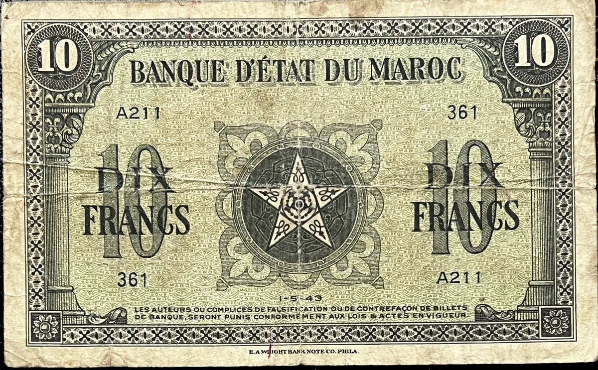 Front view of a circulated 1943 Banque d’État du Maroc 10 Francs banknote featuring a five-pointed star medallion between classical columns, printed by E.A. Wright Bank Note Co.