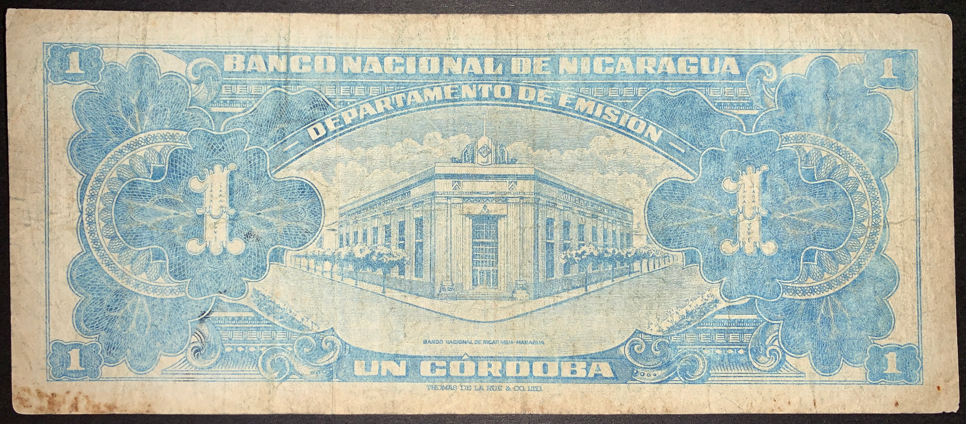Nicaragua 1 Córdoba 1957 P-99b banknote reverse featuring Banco Nacional de Nicaragua building, decorative floral motifs, and classic blue intaglio currency artwork