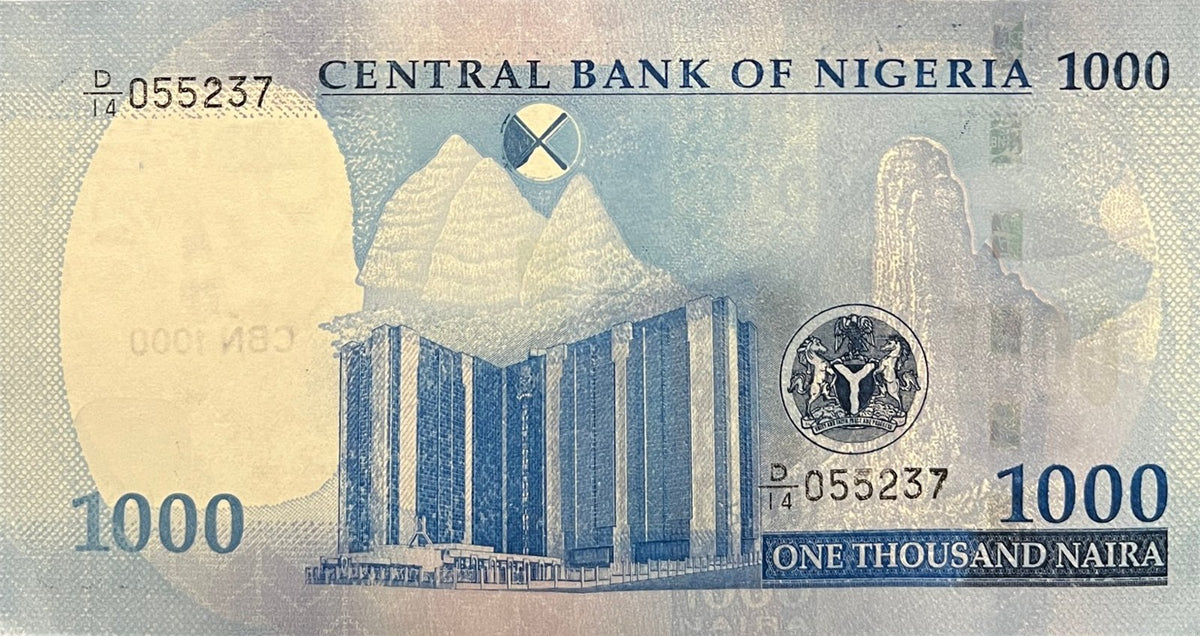 Back view of a 2025 Nigeria 1000 Naira banknote showing the Central Bank of Nigeria headquarters in Abuja and Chappal Waddi mountain.