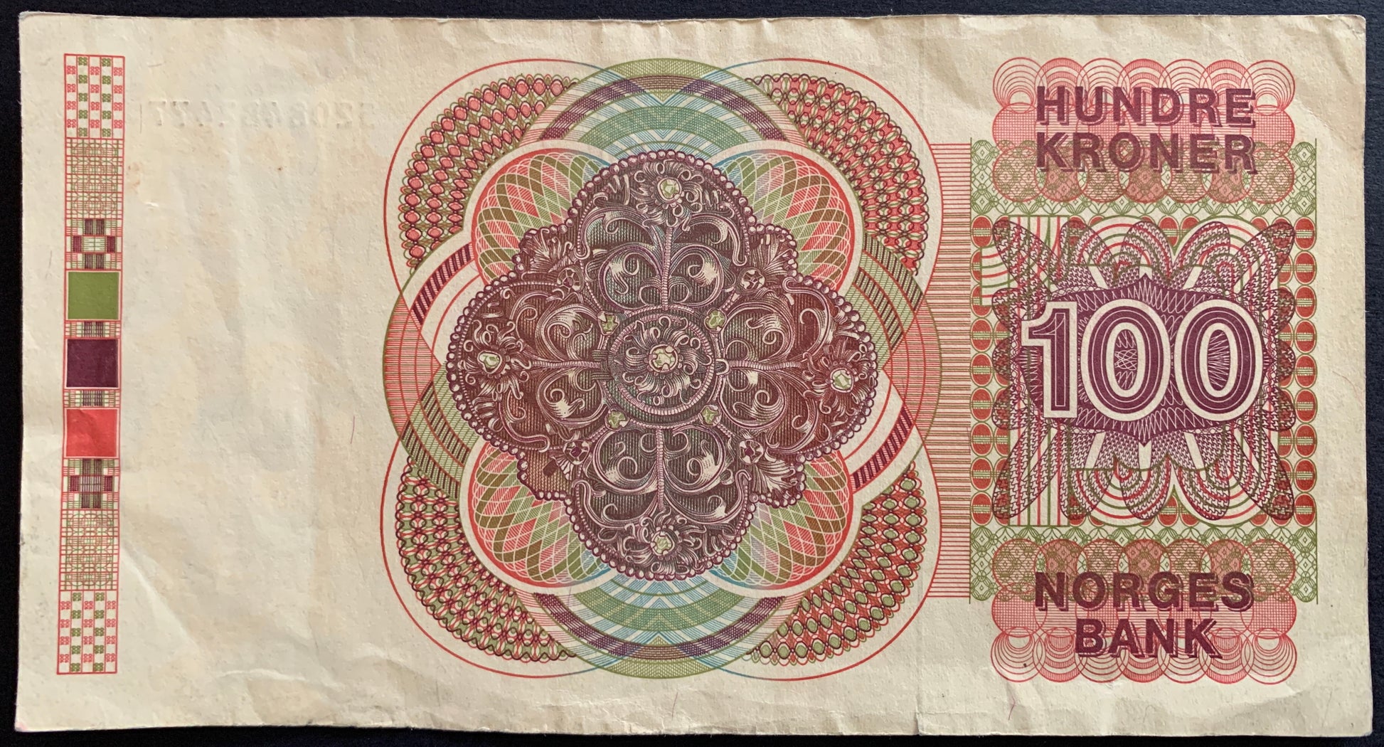 Back of the 1986 Norway 100 Kroner banknote (P-43c) displaying Norwegian cultural and historical motifs with fine engraved details, shown in VF condition.