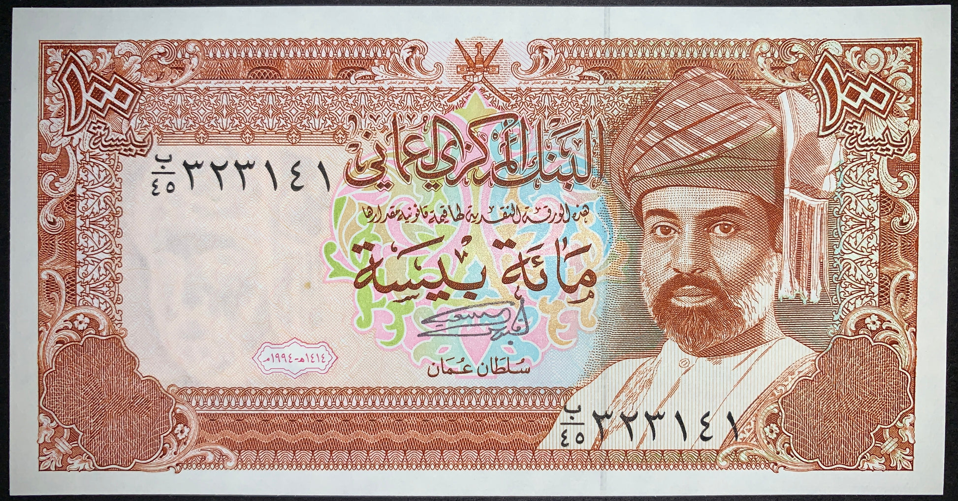 Oman 100 Baisa 1994 P-22d banknote front showing Sultan Qaboos bin Said portrait, Arabic calligraphy, ornate brown engraving, and traditional Omani design elements